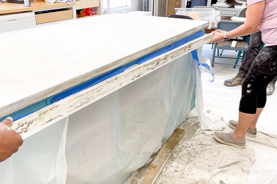 Pulling the form off the side of the kitchen island concrete countertop. 