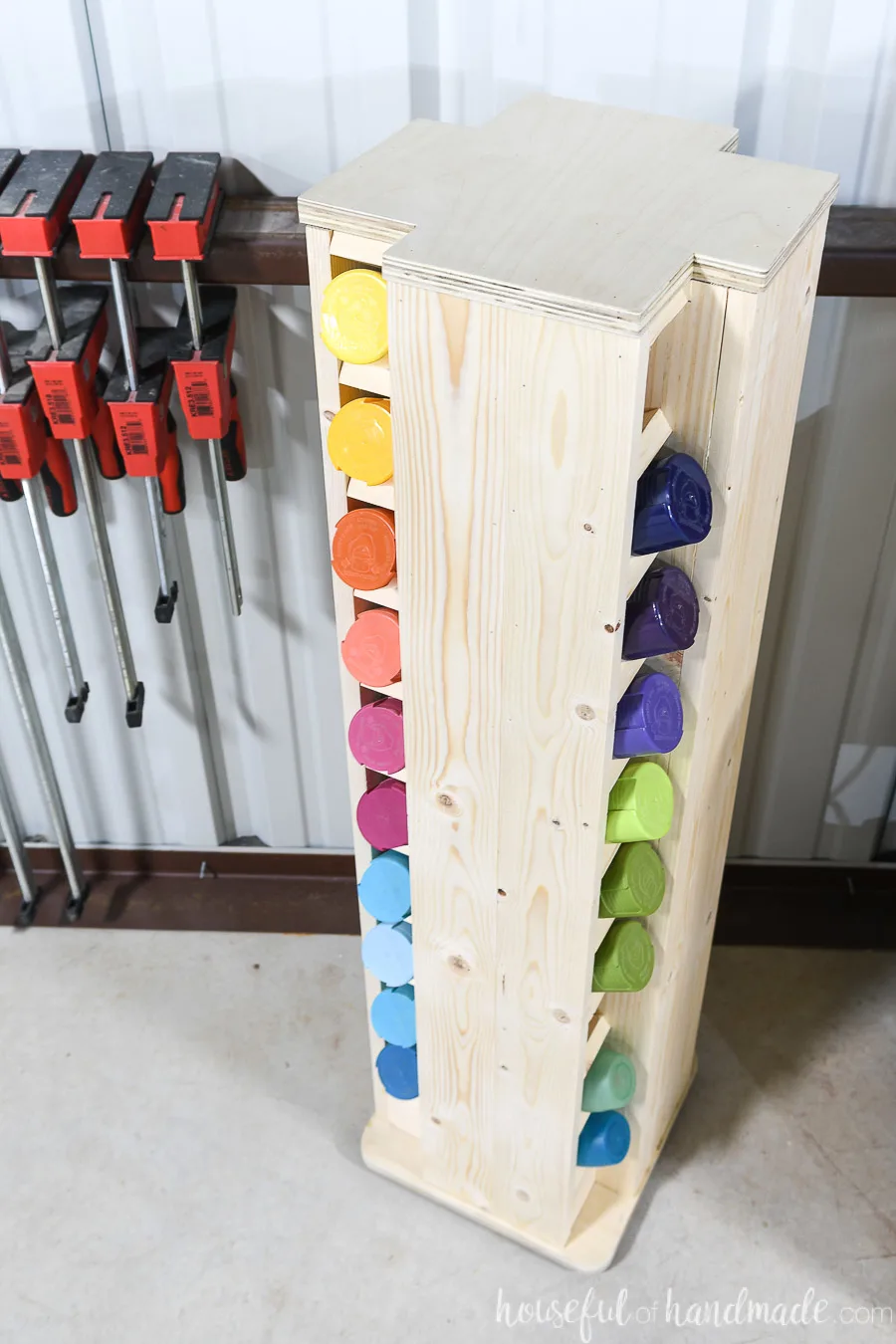 Looking down on the spray paint cabinet seeing 20 of the 40 cans it holds organized by color. 