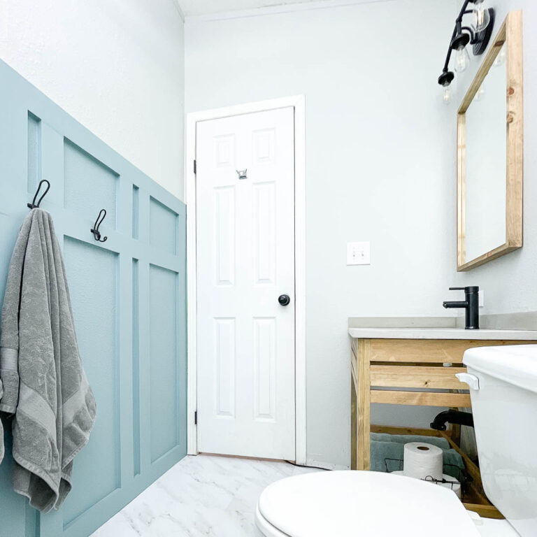 Small bathroom remodeled as part of the $100 Room Challenge with new vanity, floor and wall treatments.