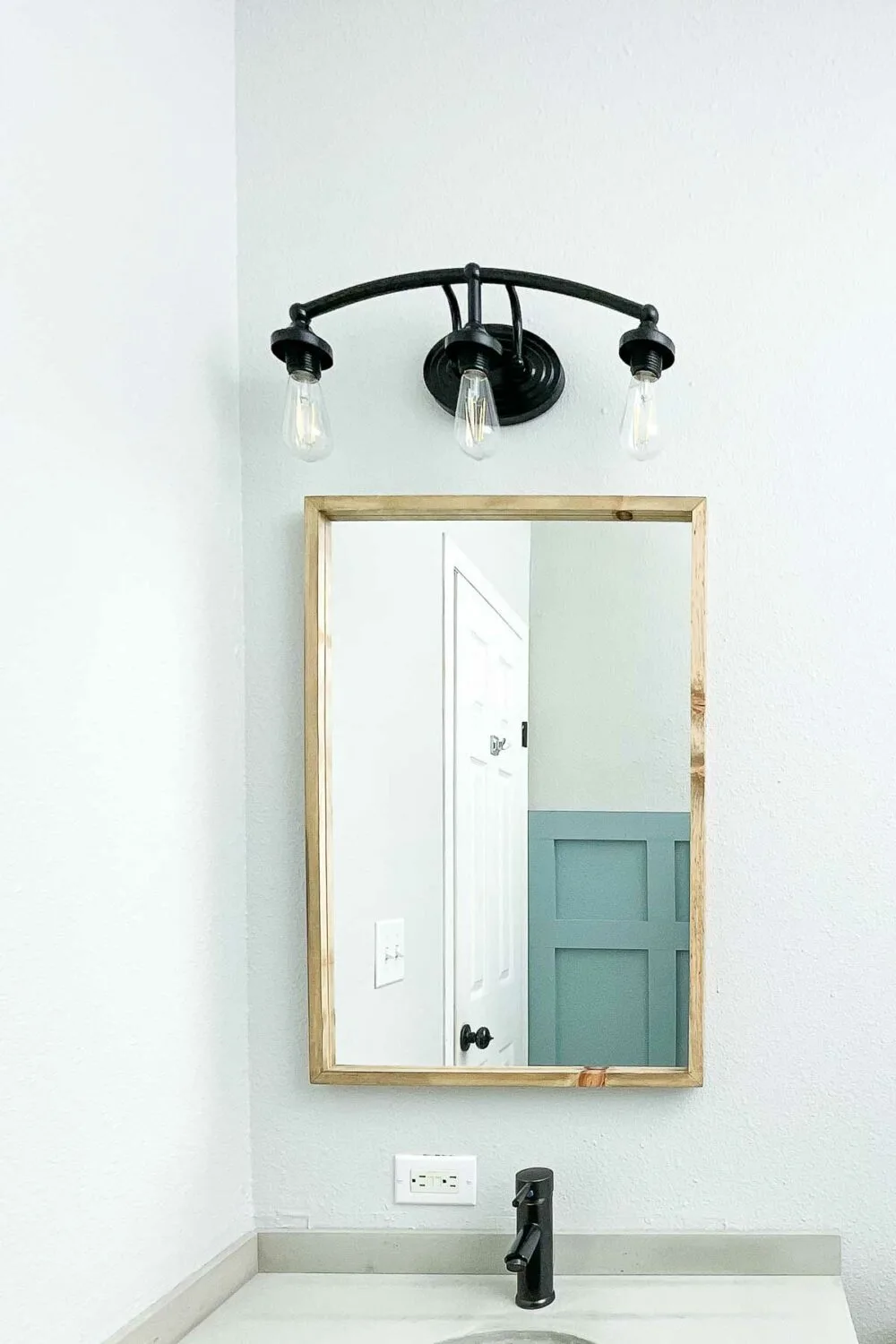 Thin framed bathroom mirror in the $100 bathroom remodel. 