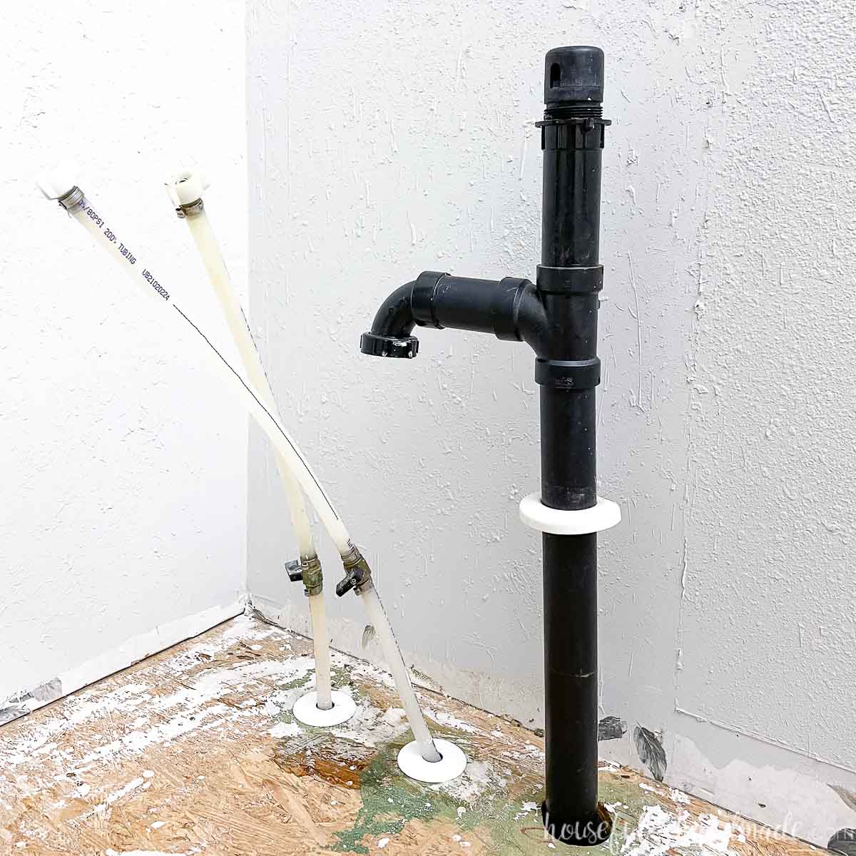 Picture of the pipes found inside the bathroom sink during the budget bathroom makeover.