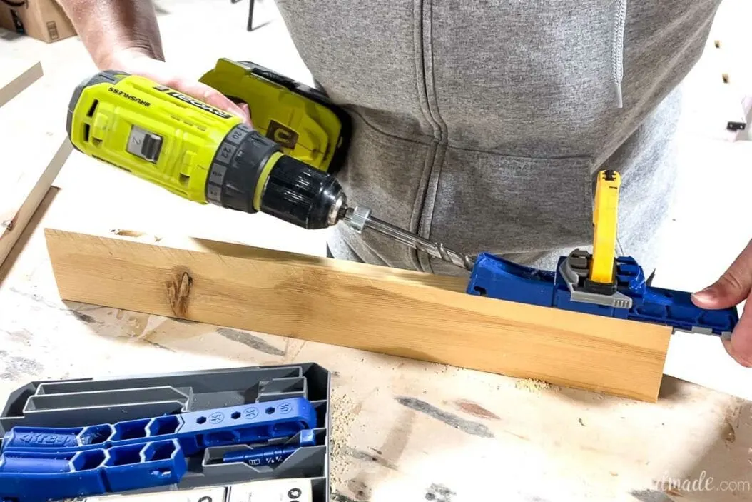 Drilling a pocket hole on the edge of the 1x3 board with the Kreg jig 320.