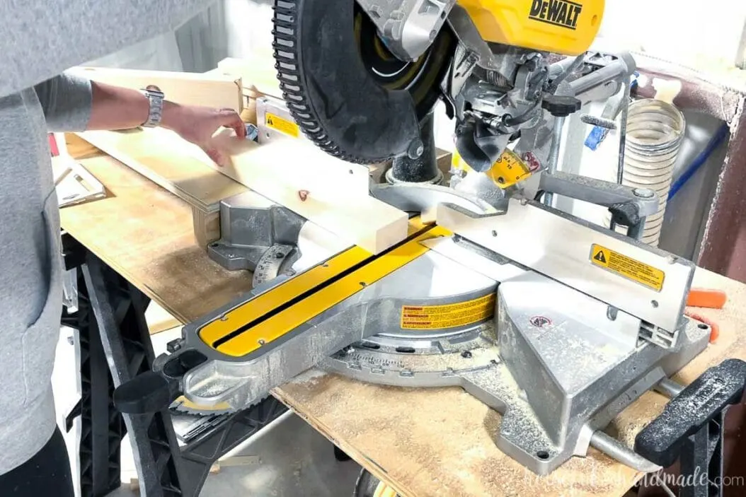 Cutting the 2x4 piece on a miter saw at a 5 degree angle.