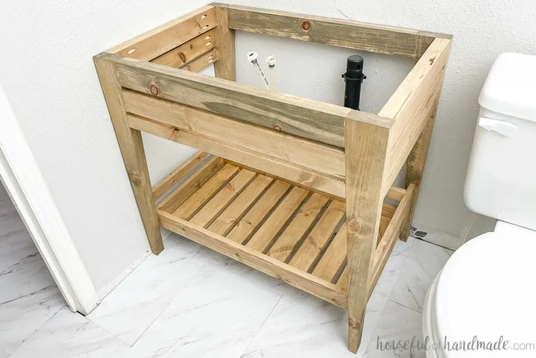 Picture of the finished DIY bathroom vanity with an open shelf and tapered legs.