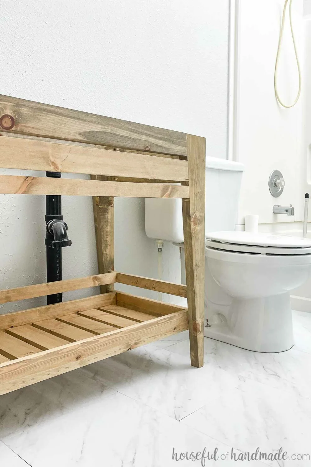 Looking into the small bathroom with the DIY open shelf bathroom vanity installed. 