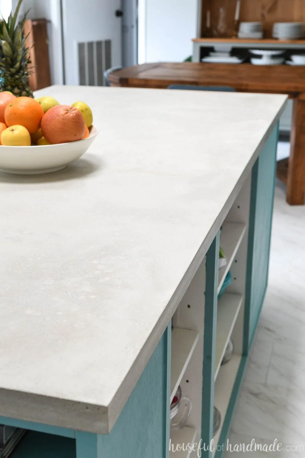 Side of a colorful kitchen island with a DIY concrete countertop.