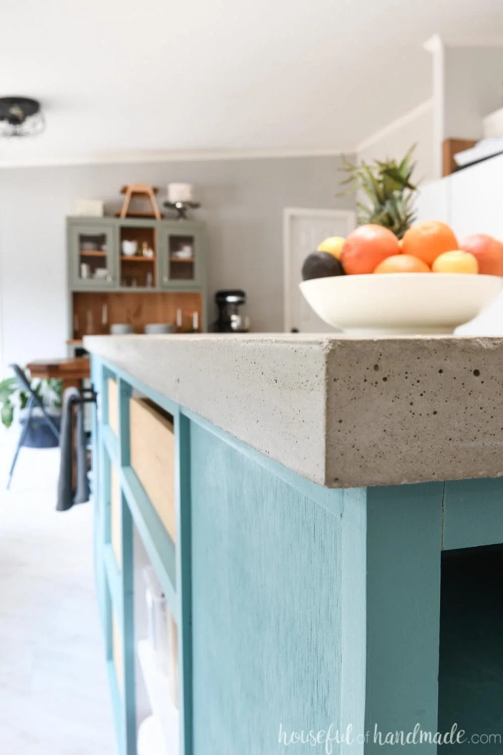 Close up of the edge of the 1 1/2" thick DIY concrete countertop on the kitchen island. 