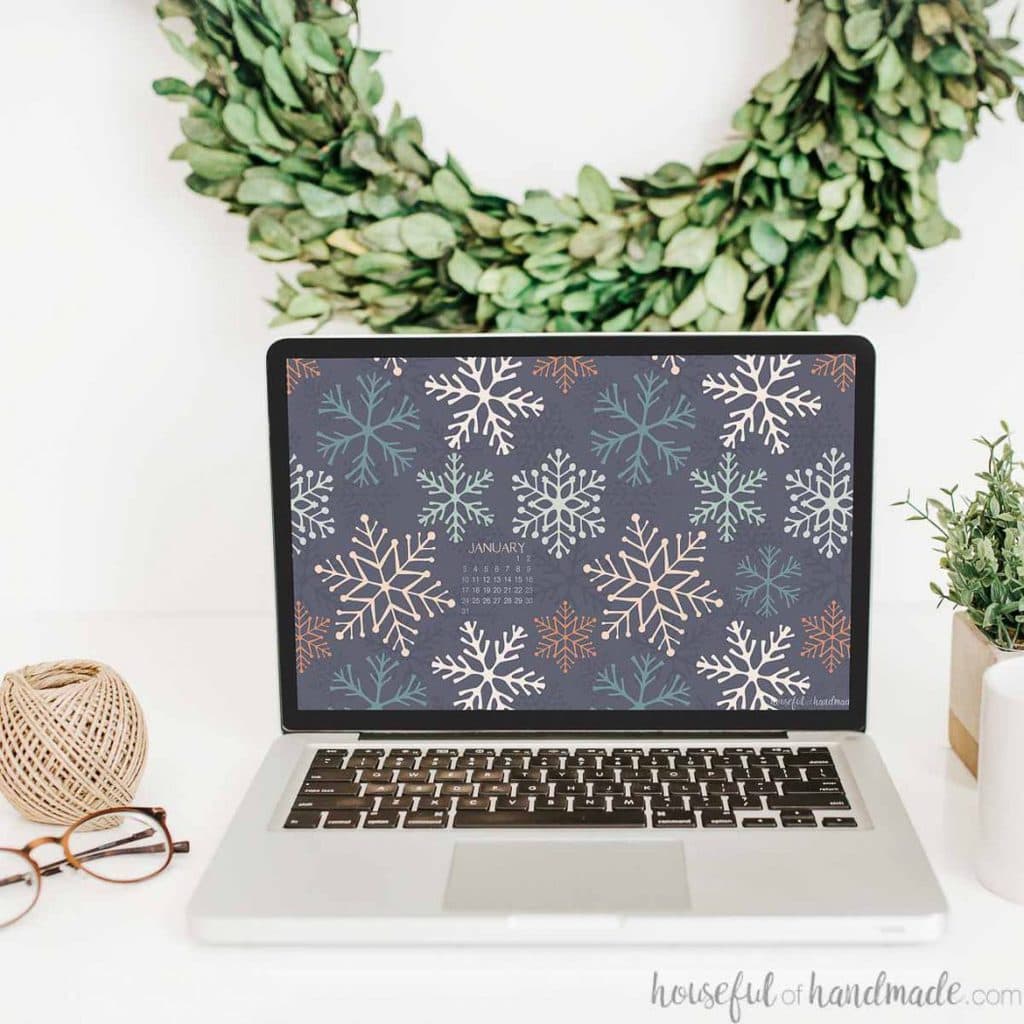 Laptop with the screen up showing the non-traditional snowflake design of the digital backgrounds on the screen.
