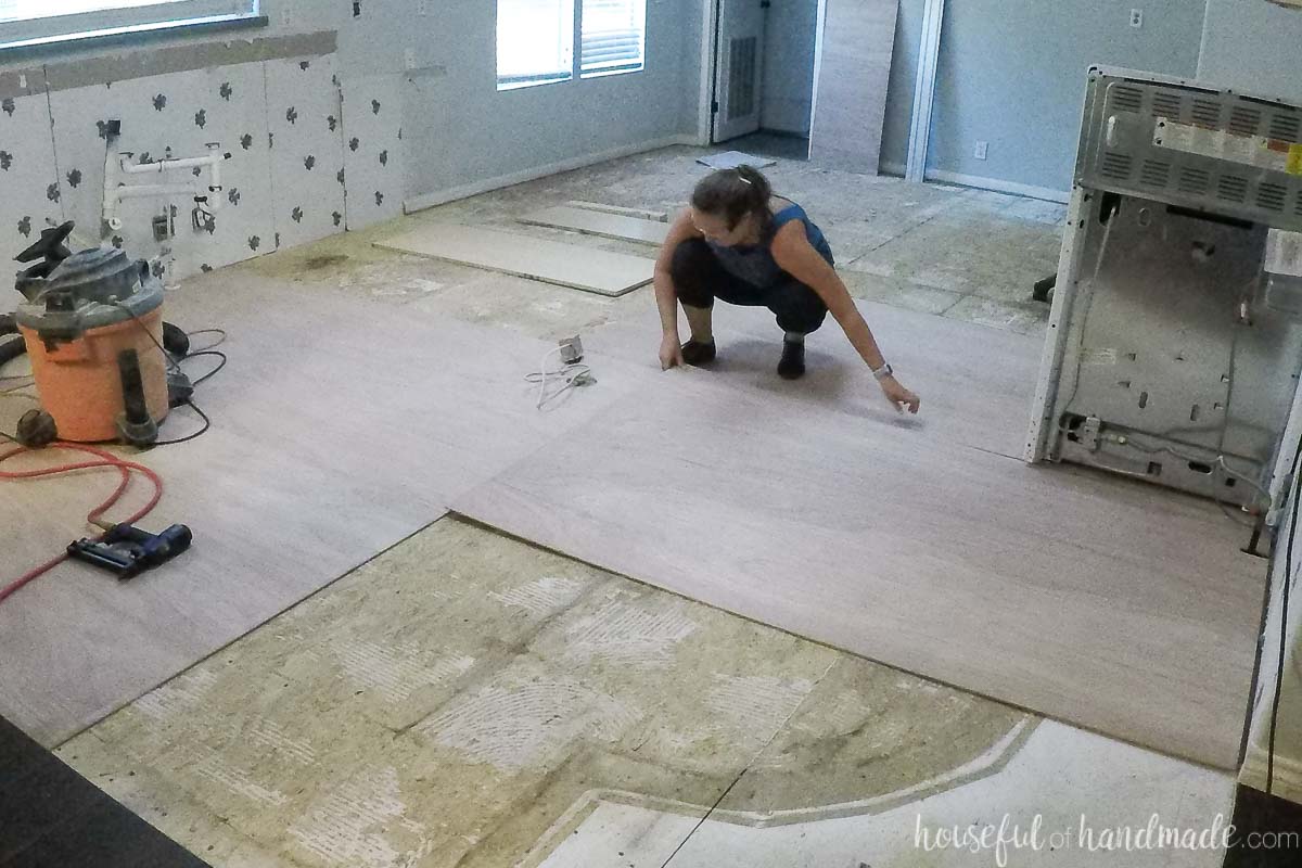Laying the 4x8 sheets of underlayment over the demoed floor with the seams staggered. 