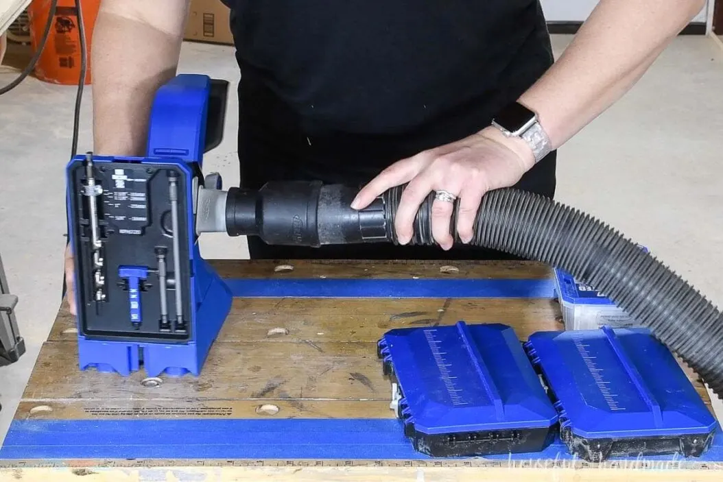 Dust blade adapter on the pocket hole jig with a shop vac hose attached.