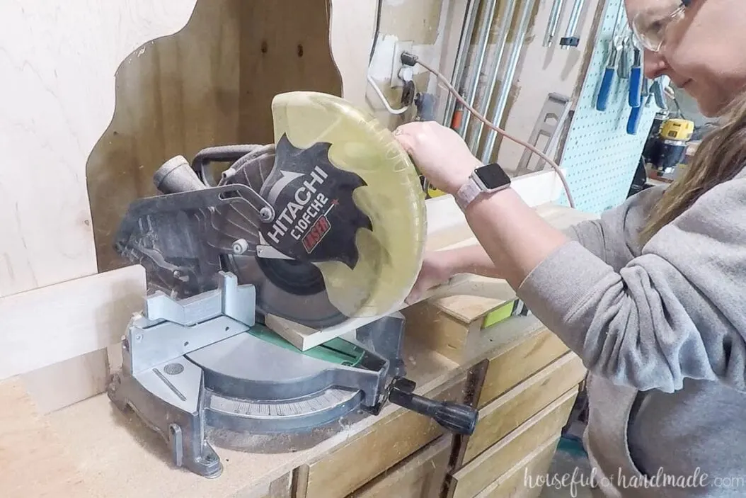 Cutting the legs for the bench with a miter saw at an angle. 