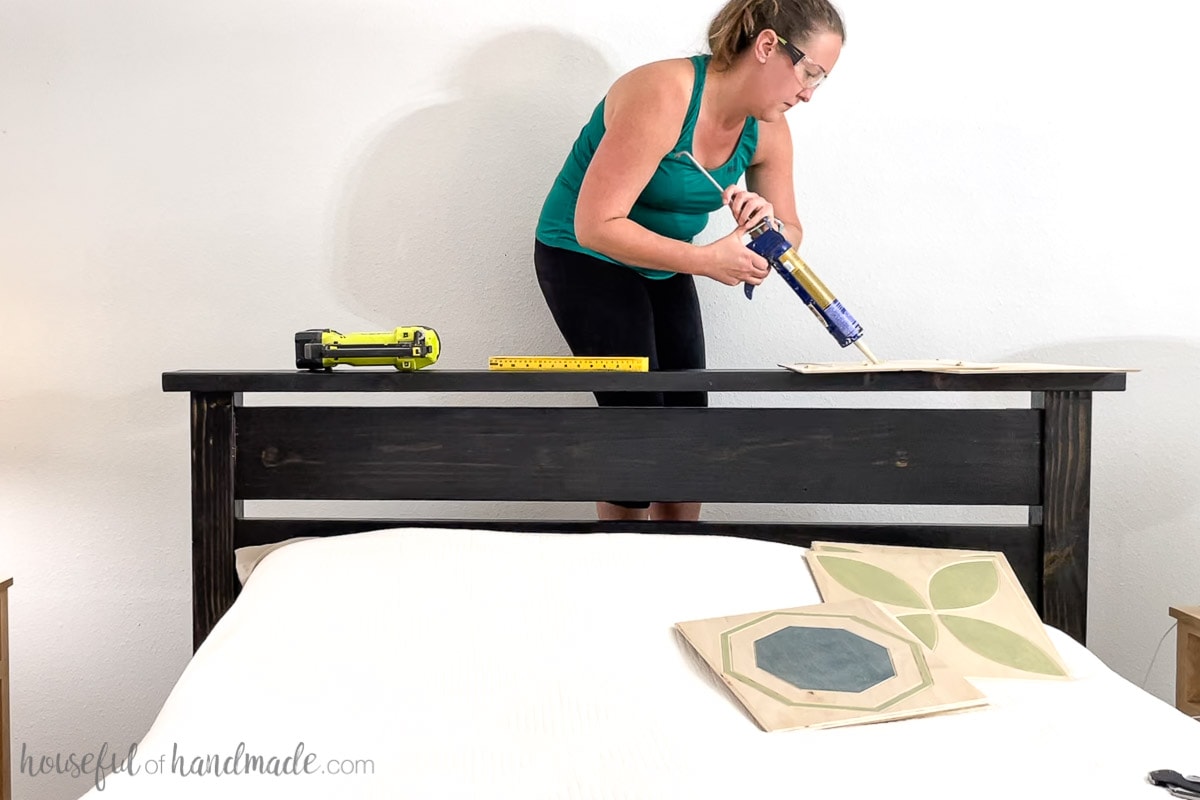 Adding liquid nails to the back of the tile to attach to the wall. 