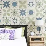 Bedroom accent wall made of carved wood tiles with patterned tile designs on it.