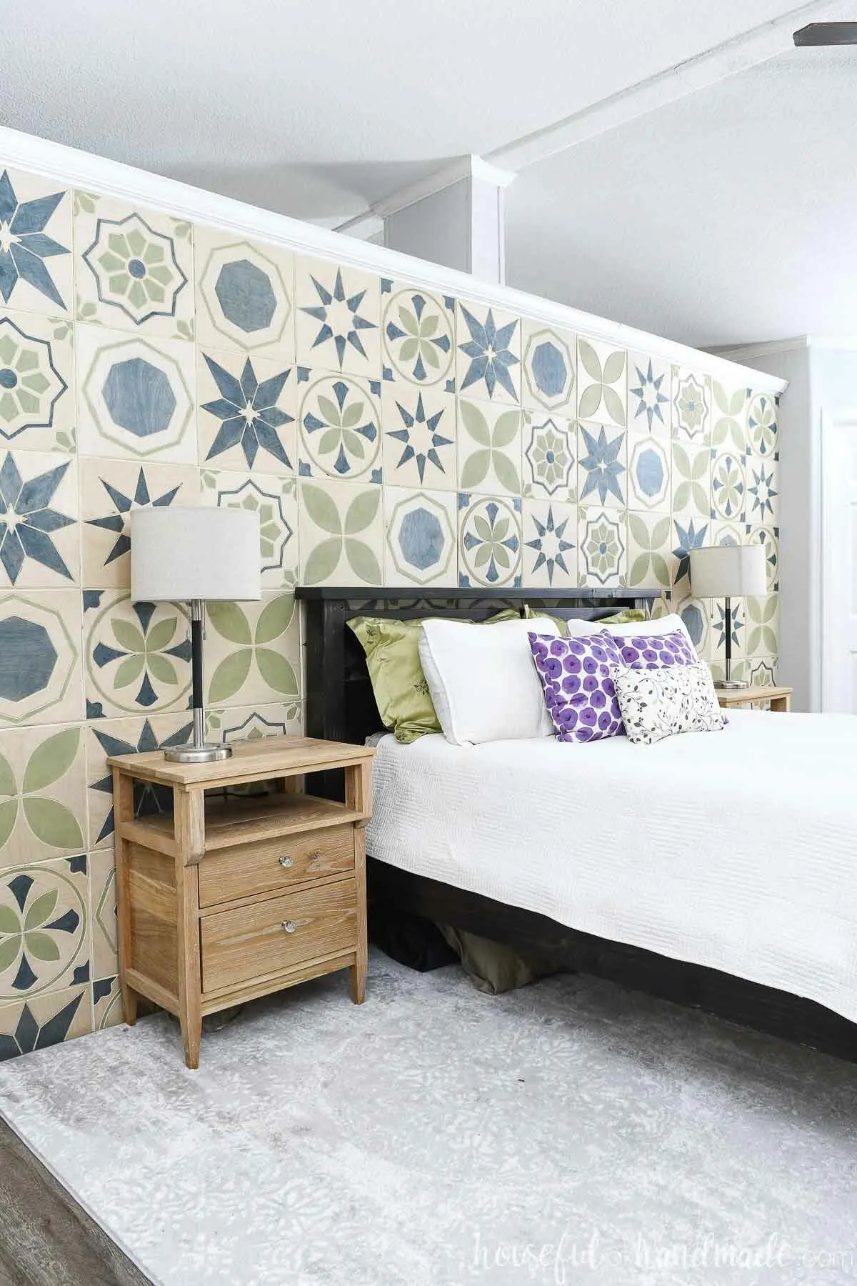 Master bedroom with a DIY accent wall made of patterned wood tiles on the wall behind the bed. 
