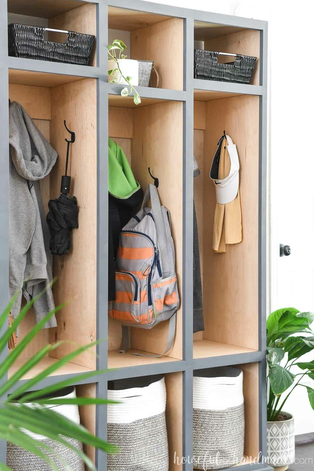 Close up view of the side hooks in the center compartment of the mudroom storage cabinet. 