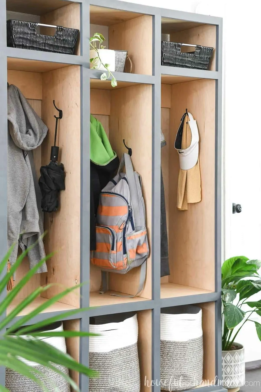 Close up view of the side hooks in the center compartment of the mudroom storage cabinet. 