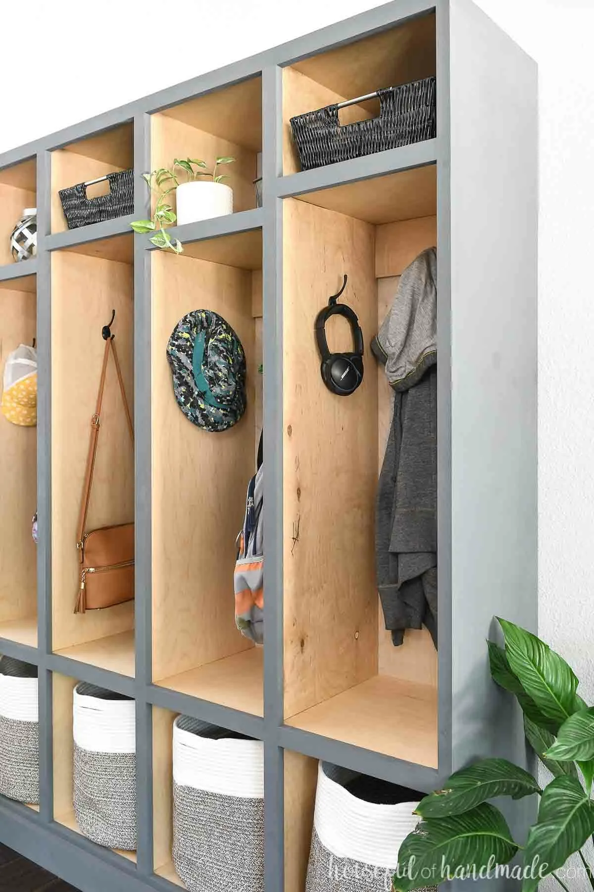 Side view of the mudroom lockers with birch wood inside and painted gray outside. 