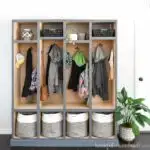 Straight on view of the DIY mudroom storage lockers with light wood inside and gray-blue painted outside.