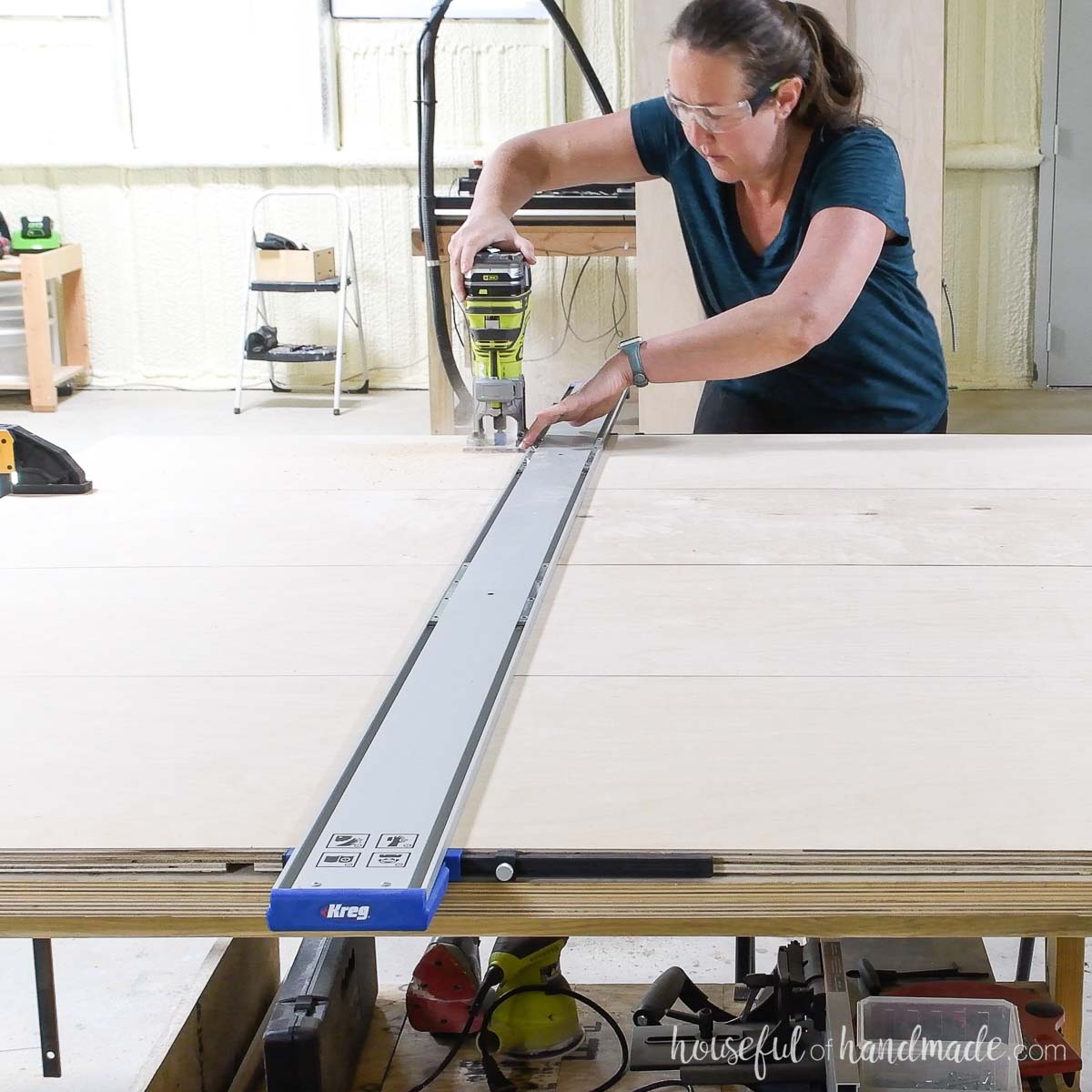 Routing out a groove for the shelves in the plywood pieces with a straight edge guide. 