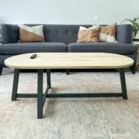 Rounded top and asymmetrical base coffee table in a living room.