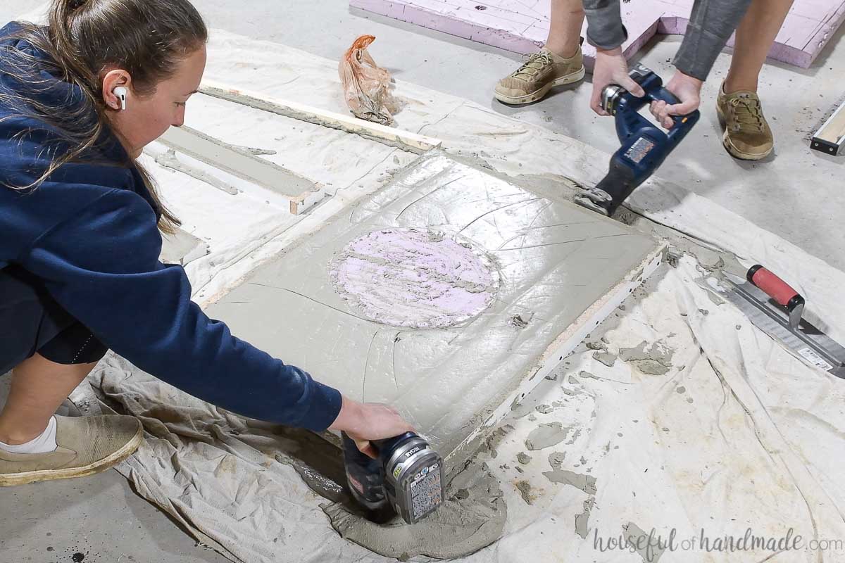 Vibrating the cement with a sawsall and electric sander. 