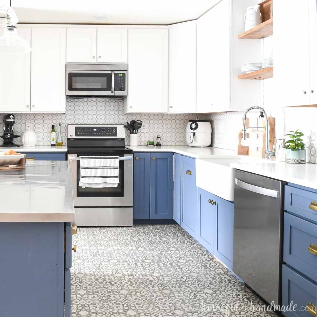 Blue and white kitchen cabinets in an open kitchen with full overlay cabinet doors.