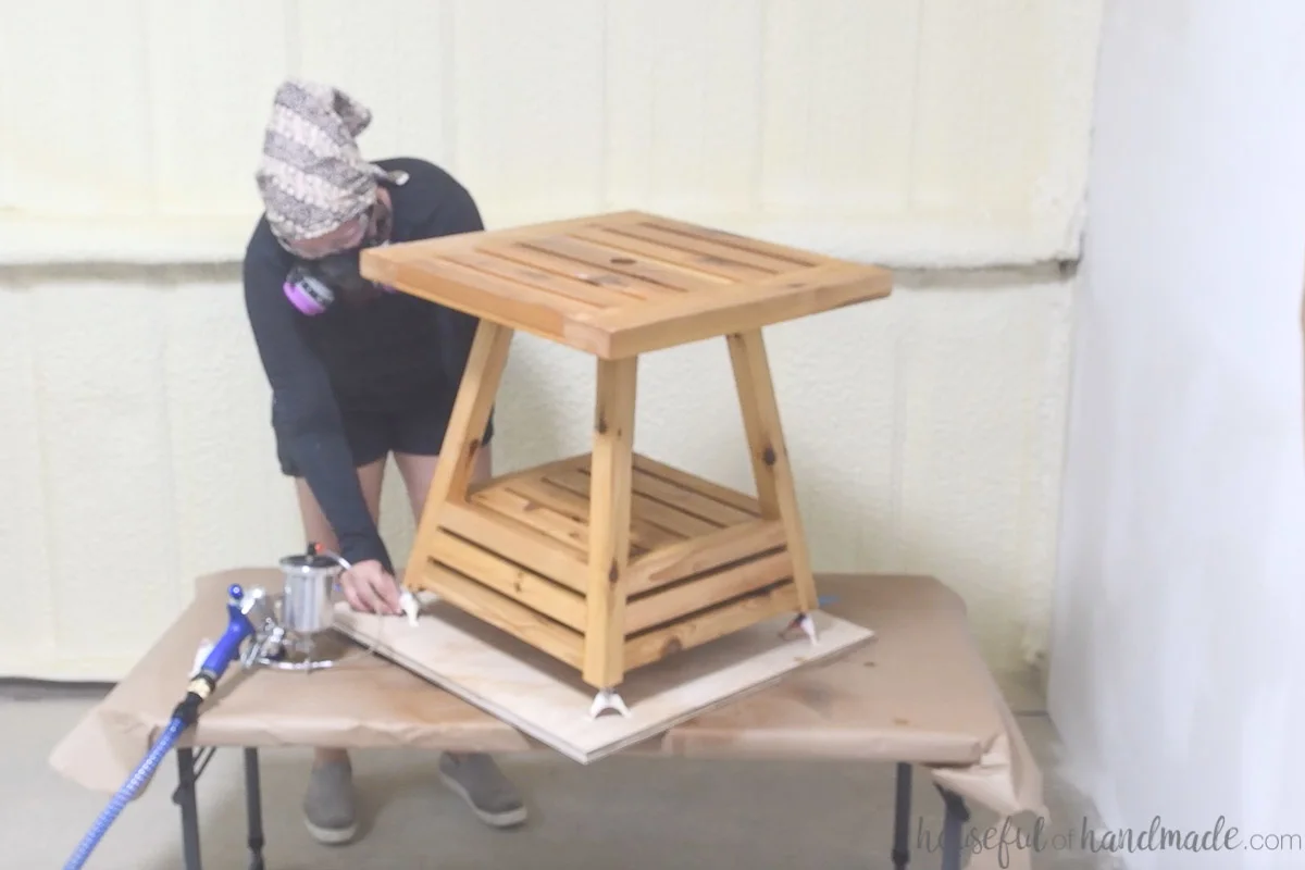 Placing paint pyramids under each foot of the side table while spraying the finish. 