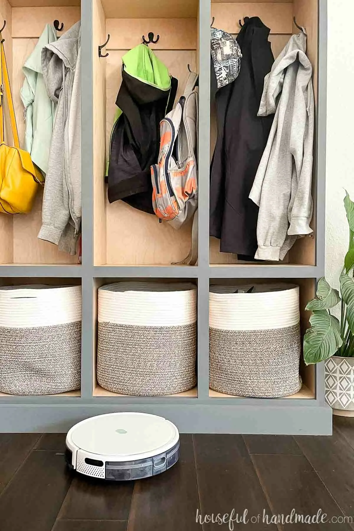 DIY mudroom storage lockers with robot vacuum cleaning around the base. 