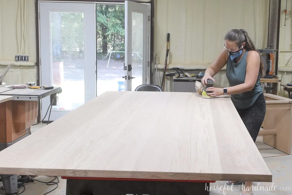 Sanding the final grit of the table top refurbish with an orbital sander. 