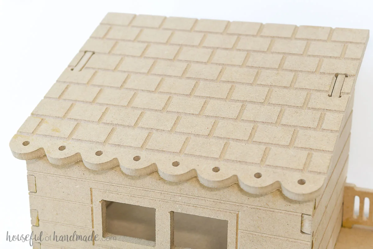 Close up of the shingle texture carved into the roof of the MDF dollhouse. 