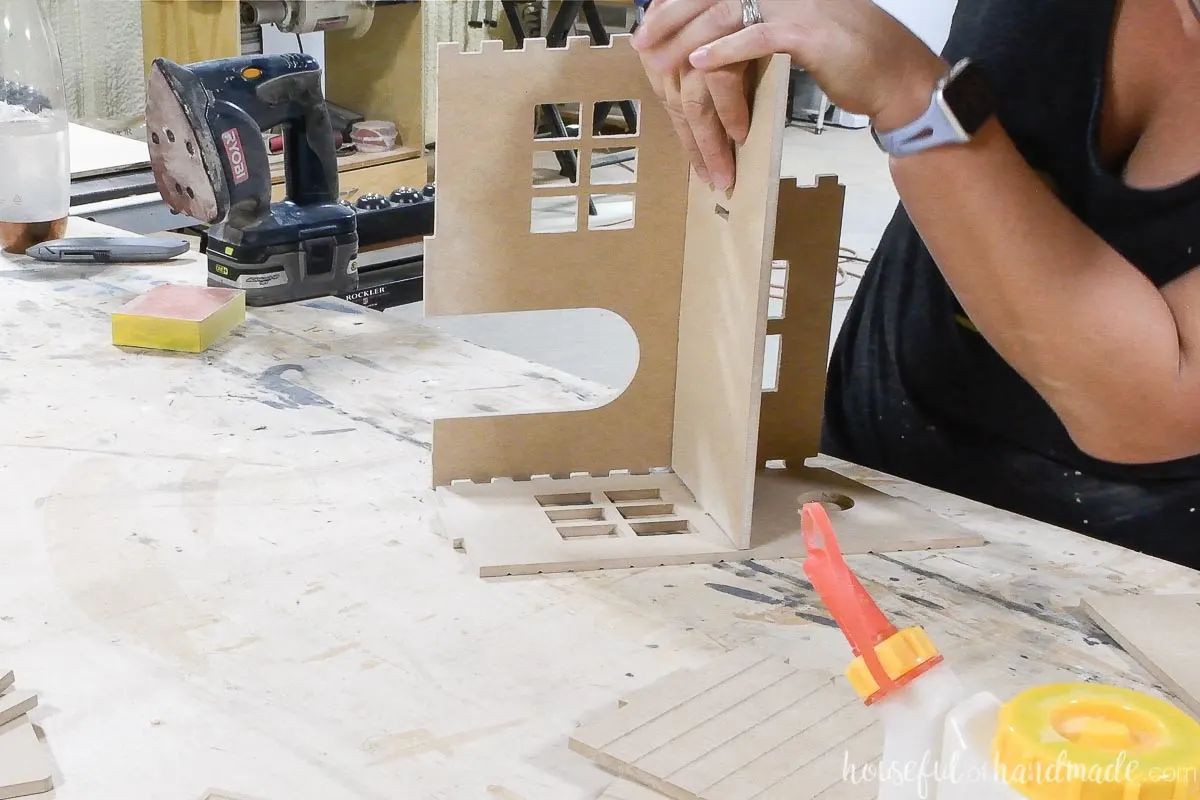 Attaching the side of the MDF dollhouse into the second floor tabs and notches on the front of the house.