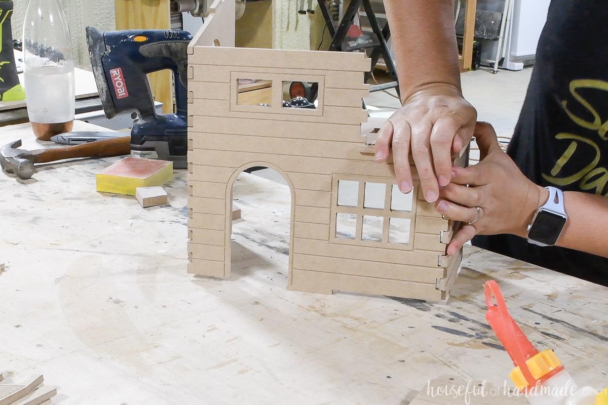 Attaching the second side of the CNC dollhouse. 