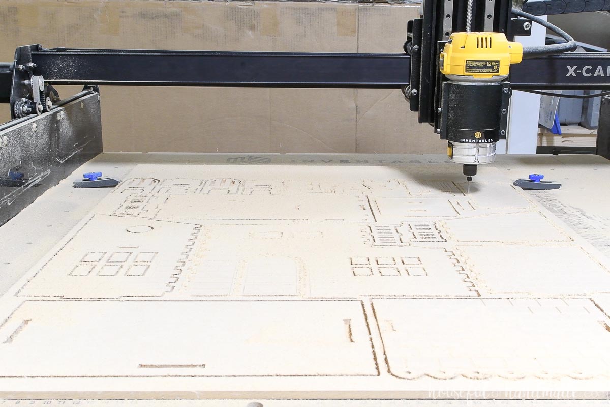 MDF dollhouse pieces being cut out with a CNC machine using a straight bit. 