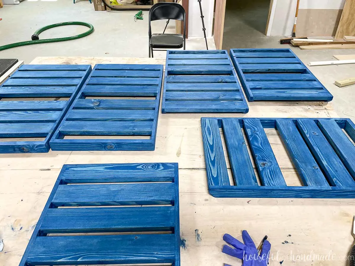 All 6 plant shelves for the tiered corner stand stained a bold blue. 