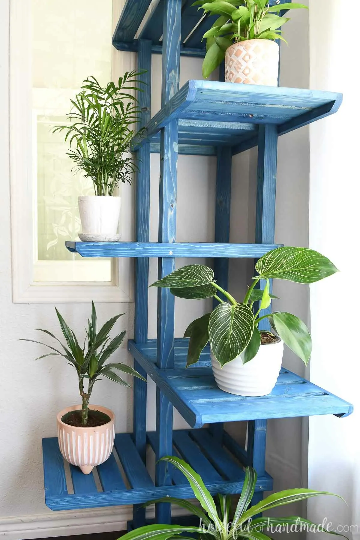 Close up view of the large shelves on the corner plant stand. 