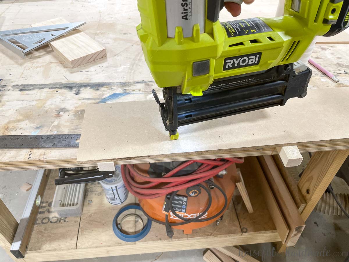 Stapling the boards to the table saw jig to secure. 