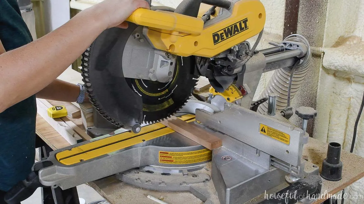 Cutting 1x2 cherry boards on a miter saw. 