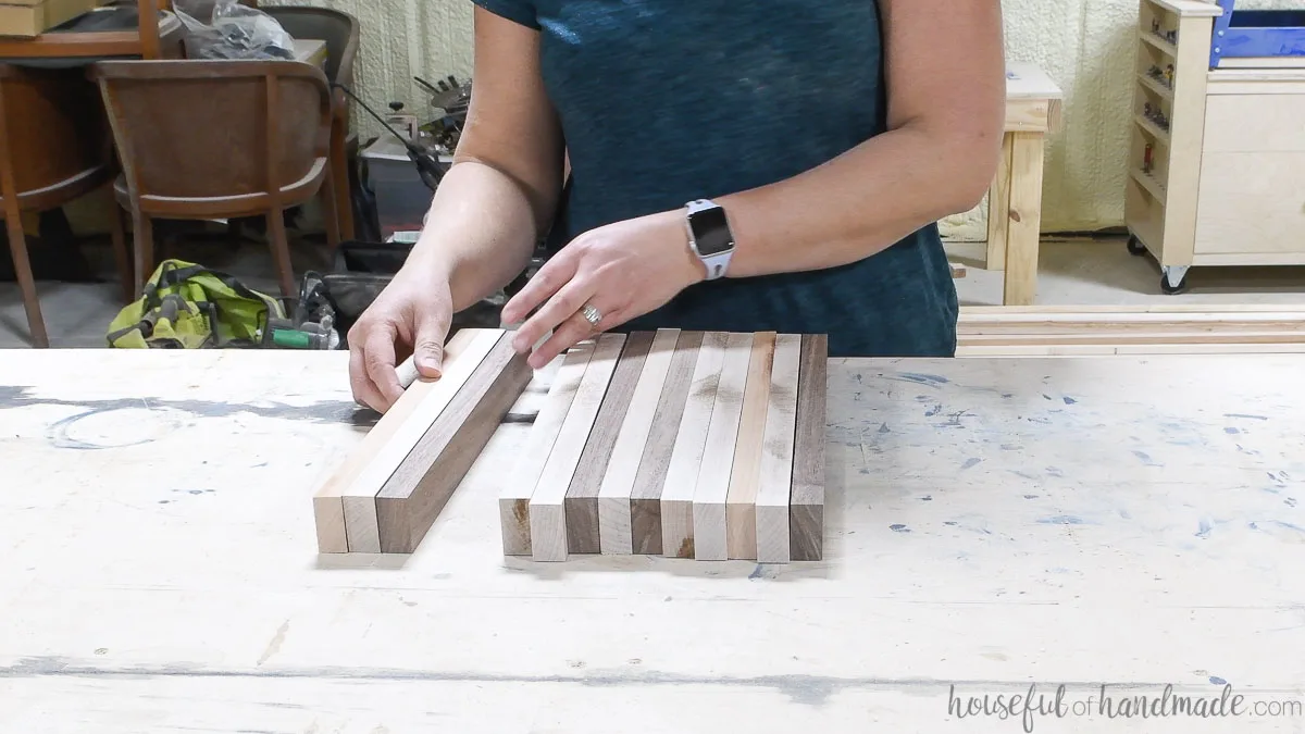 Lining up the 1x2 hardwood boards in a design for a DIY cutting board. 