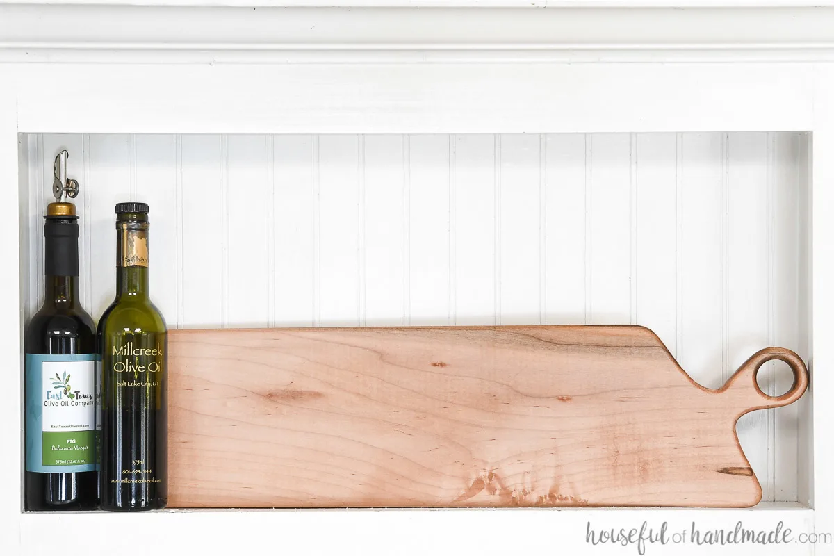 Handmade maple breadboard in a kitchen nook next to cooking oils. 