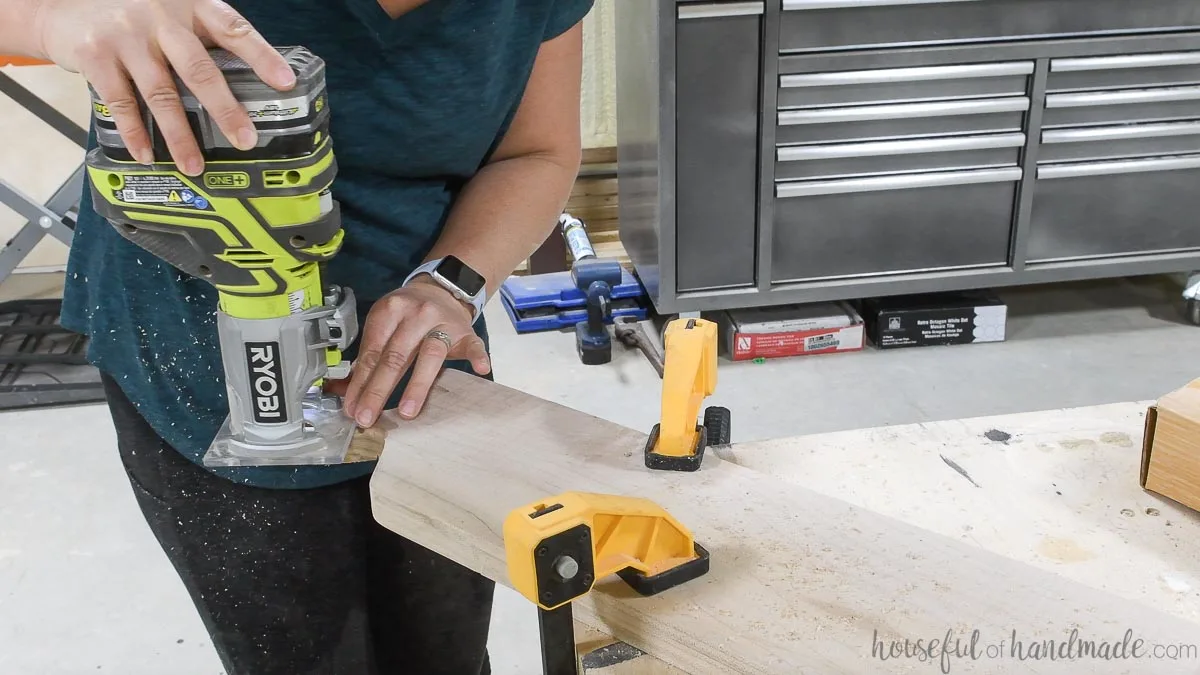 Using a trim router to round over the edges of the maple breadboard. 