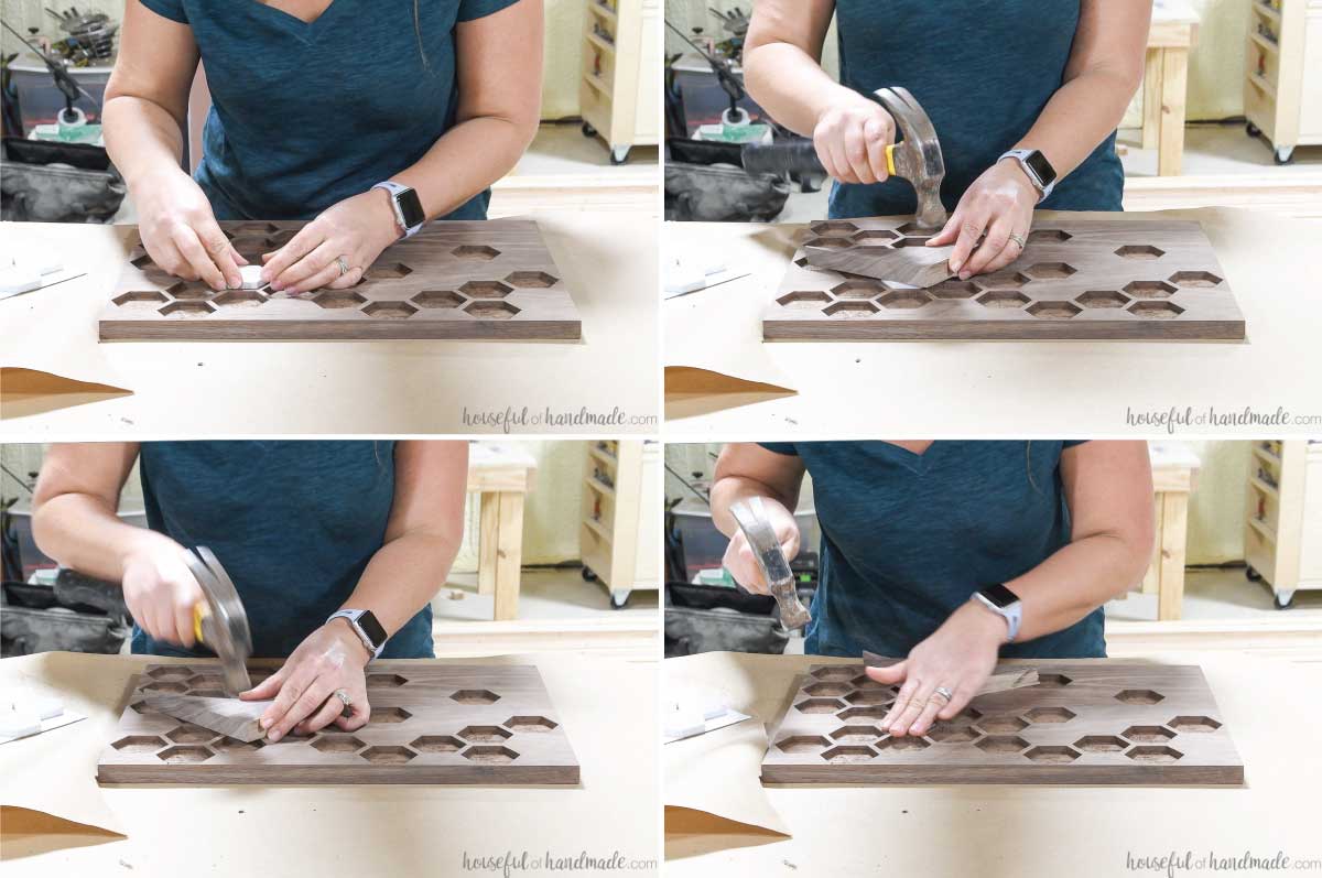 Setting the marble tiles into the tray and tapping them in place with a hammer and piece of scrap wood until they are flush to the top of the wood. 