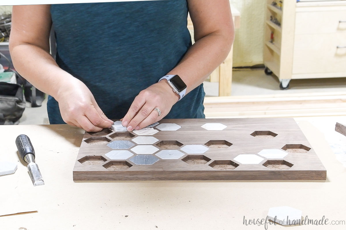 Most of the marble tiles inlaid into the walnut wood tray. 