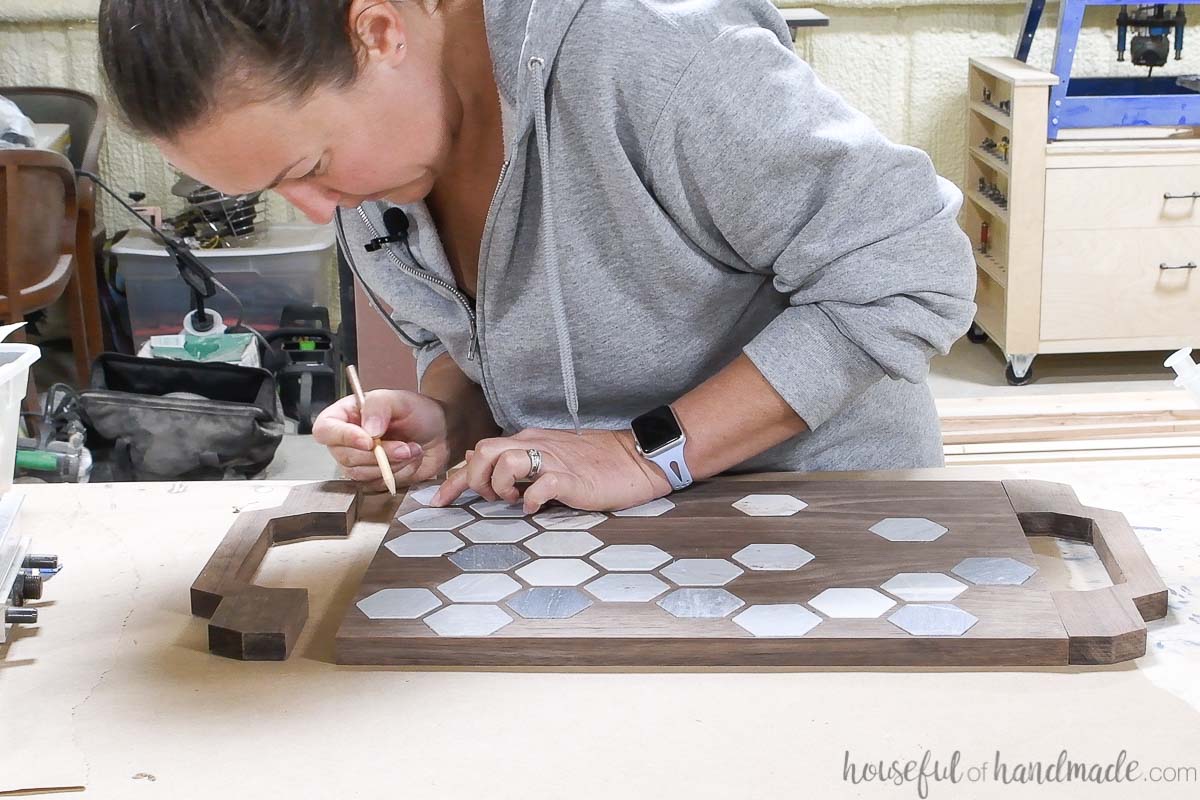 Marking the position for the dowel holes to secure the handles to the ends of the tray.