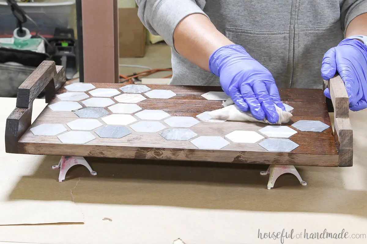 Adding tung oil to seal the marble tile inlay tray. 