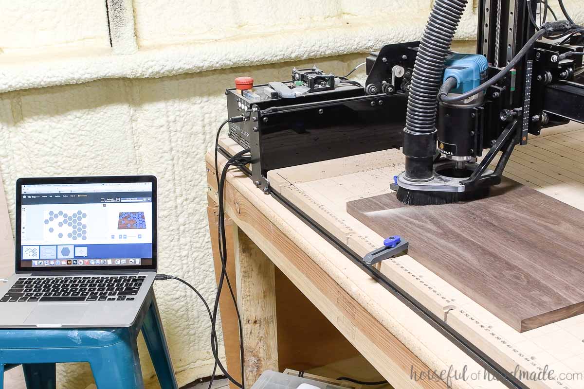 Setting up the walnut wood board on the CNC machine to carve the inlays for the serving tray. 