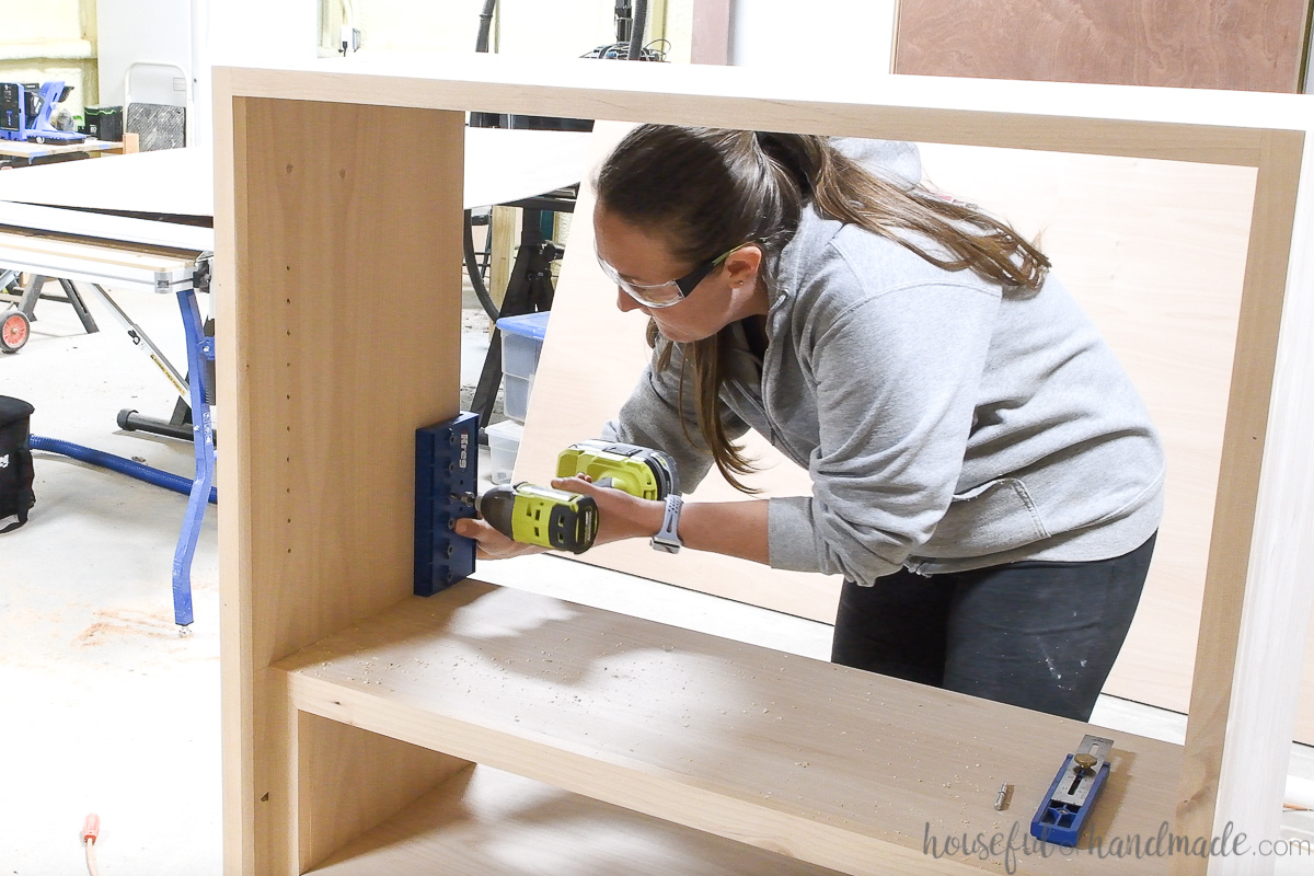 Adding shelf pin holes to the inside of the DIY display cabinet. 