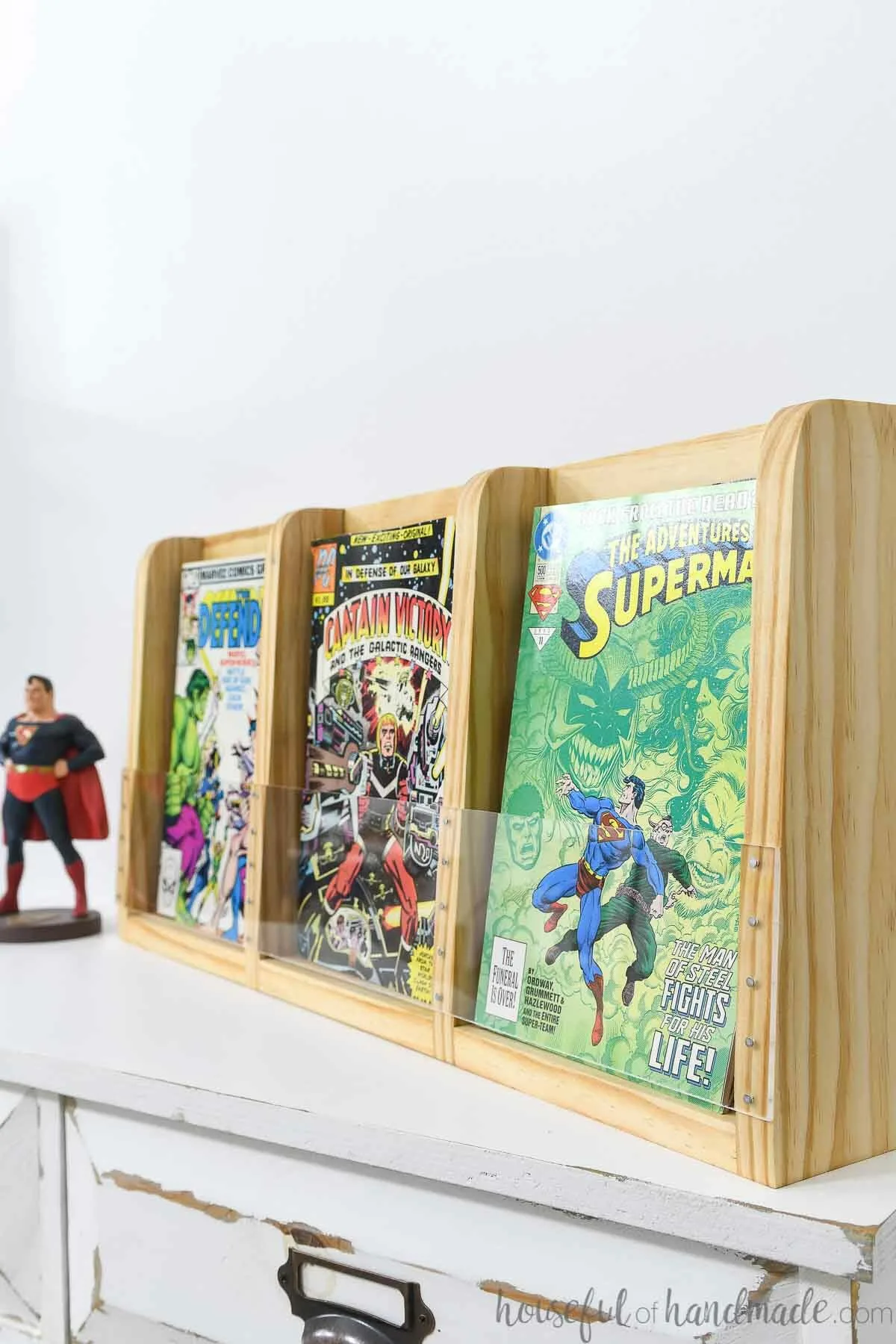 Comic book storage shelf with 3 sections filled with a variety of comic books. 