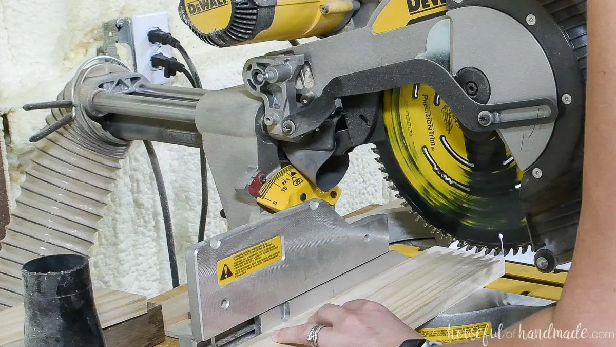 Cutting out a 1x4 on a miter saw. 