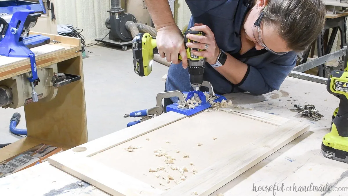 Drilling holes in the cabinet doors for concealed hinges with the Kreg jig. 