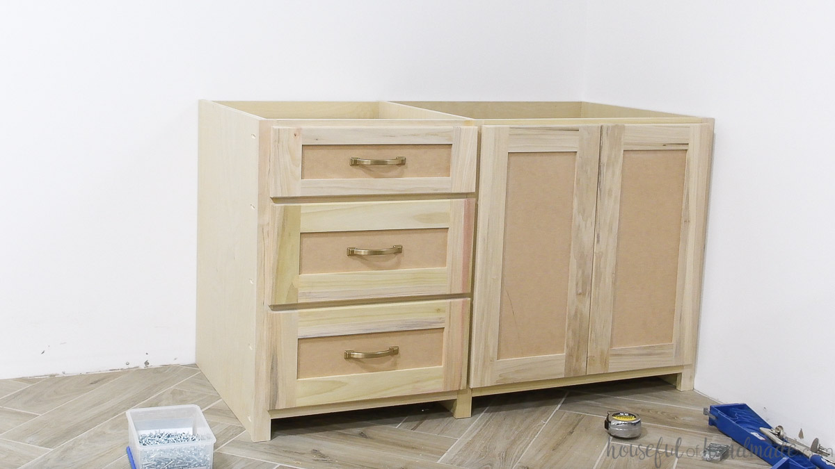 One section of the built in desk cabinets with the drawer fronts attached with pulls. 